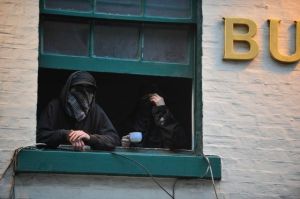 Squatters protect their identities during an eviction